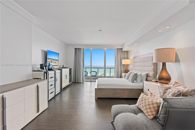 bedroom featuring a water view, dark wood-type flooring, and floor to ceiling windows