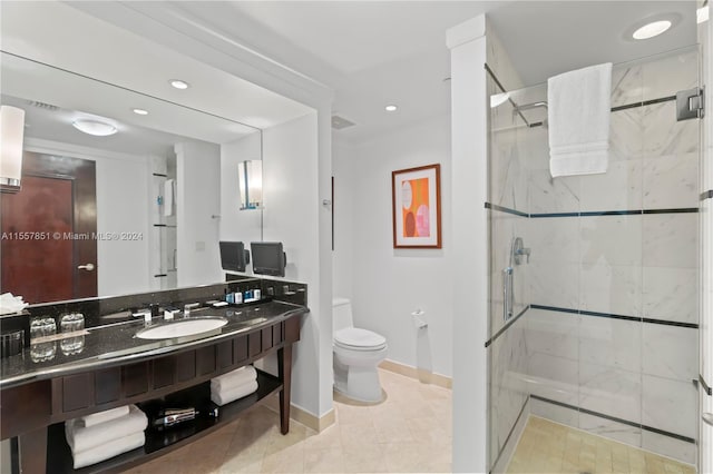 bathroom with walk in shower, large vanity, tile floors, and toilet