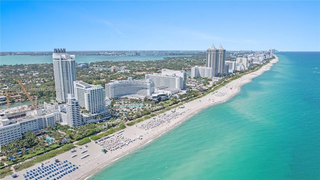 drone / aerial view featuring a beach view and a water view