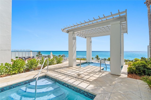 view of pool featuring a patio area, a pergola, an in ground hot tub, and a water view