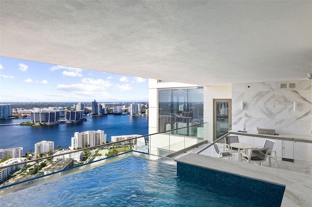 view of pool with a view of city, a water view, and a sink