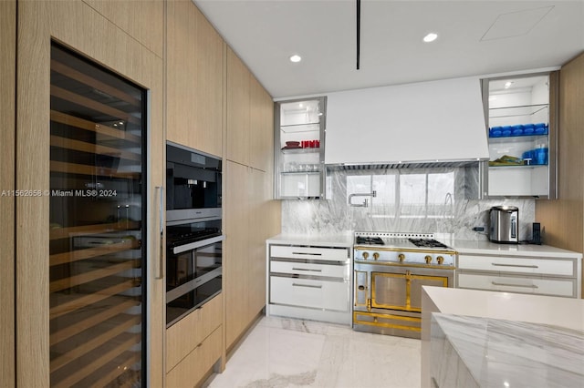 kitchen featuring backsplash, light tile floors, light brown cabinets, range with two ovens, and custom exhaust hood