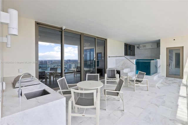 view of patio featuring outdoor dining space and a sink