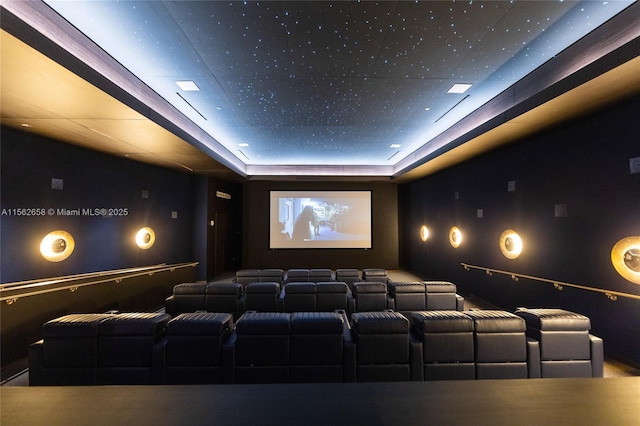 cinema room featuring a tray ceiling