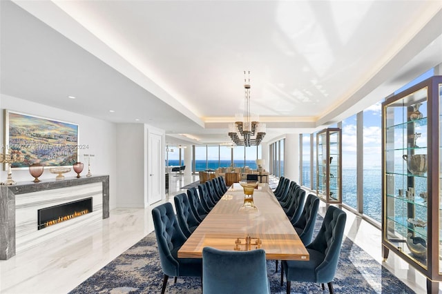 dining room with a water view and a chandelier