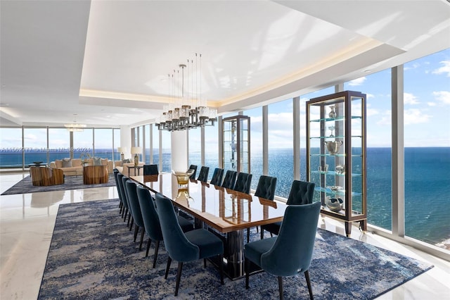 dining space featuring expansive windows and a water view