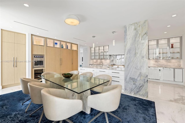 dining room featuring beverage cooler and sink