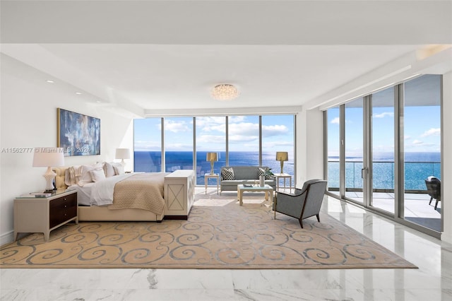 bedroom with a water view, floor to ceiling windows, and access to exterior