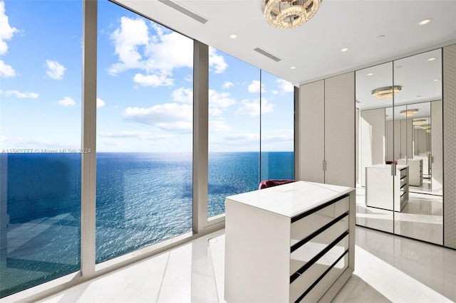 unfurnished sunroom with a water view