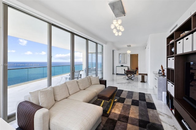 living room featuring a water view and a chandelier