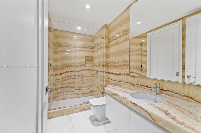 bathroom with walk in shower, vanity, and toilet