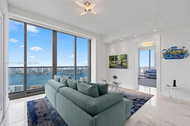 living room with plenty of natural light and a water view