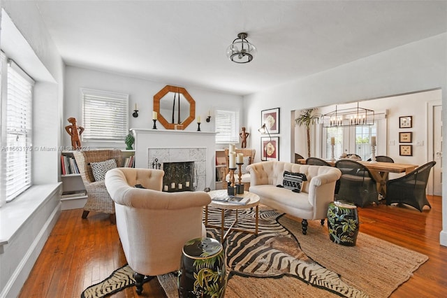 living room featuring a notable chandelier and dark hardwood / wood-style floors