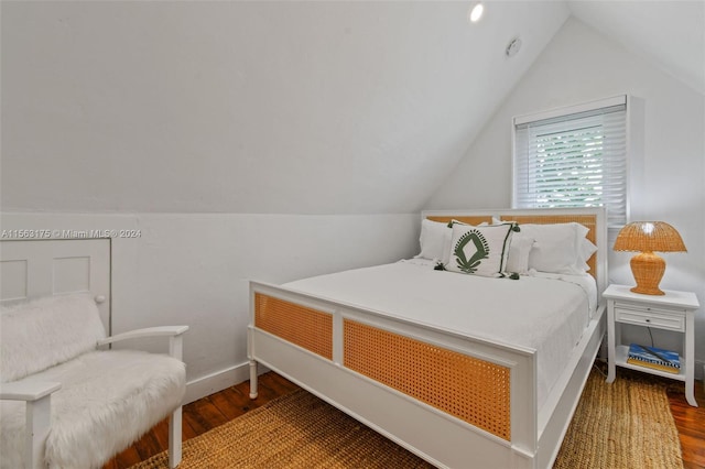 bedroom featuring lofted ceiling and hardwood / wood-style flooring