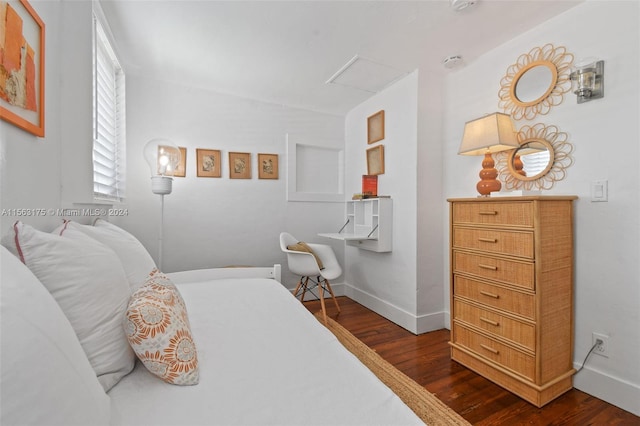 bedroom with dark hardwood / wood-style flooring