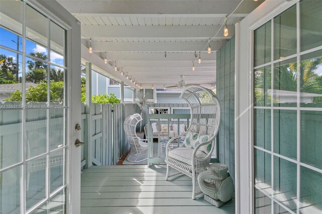 unfurnished sunroom featuring beam ceiling