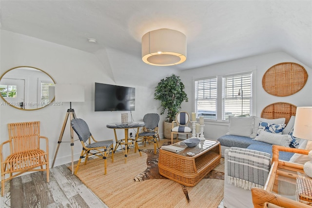 living room featuring light hardwood / wood-style flooring and vaulted ceiling