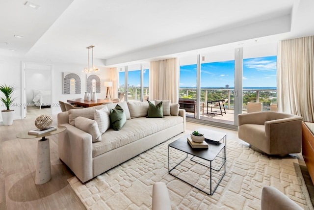 living area featuring wood finished floors and a notable chandelier