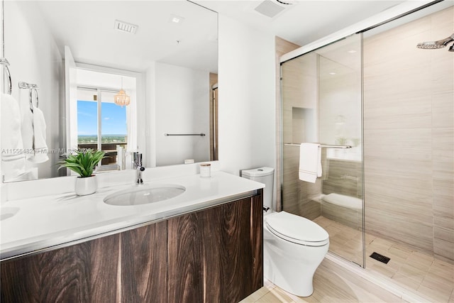 full bathroom with visible vents, a shower stall, toilet, and vanity