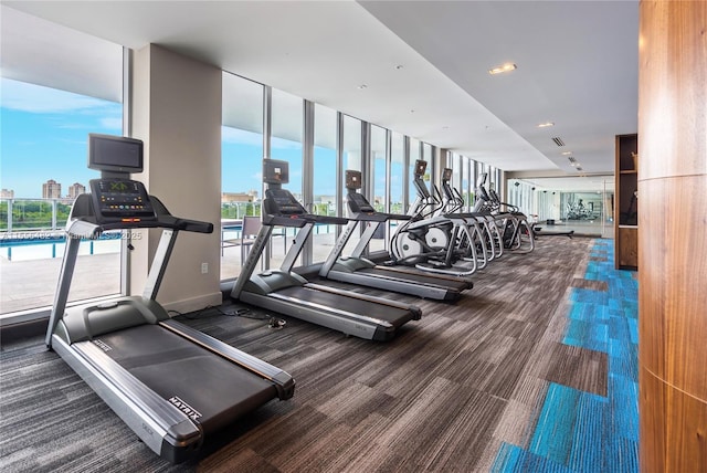 gym with carpet floors and floor to ceiling windows