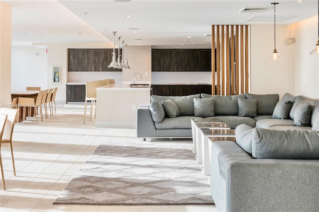 living area with light tile patterned floors, visible vents, and recessed lighting