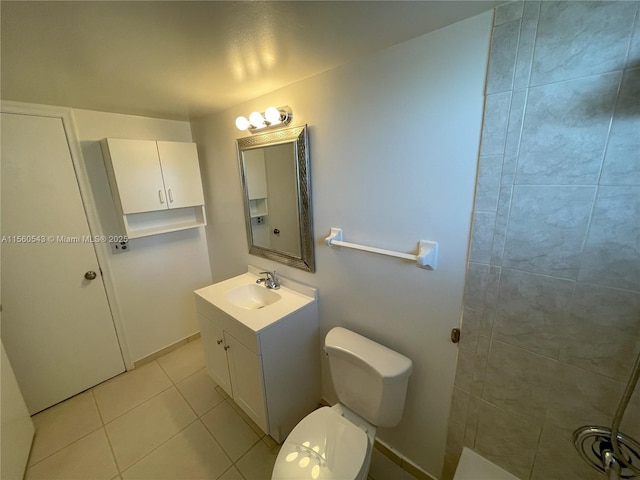 bathroom with vanity, tile patterned floors, and toilet