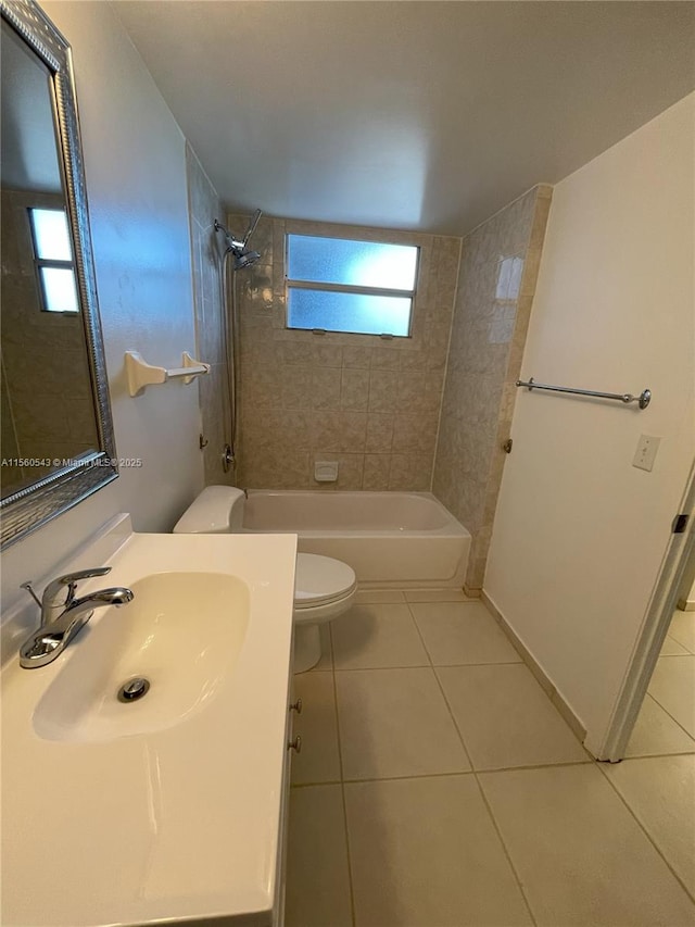 full bathroom featuring vanity, tiled shower / bath combo, tile patterned floors, and toilet