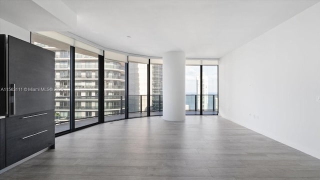 empty room featuring floor to ceiling windows and a healthy amount of sunlight