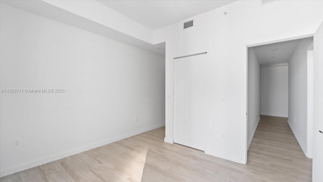 spare room featuring light hardwood / wood-style floors