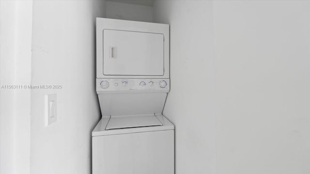 laundry area with stacked washer / dryer