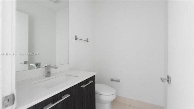 bathroom featuring tile patterned flooring, vanity, and toilet