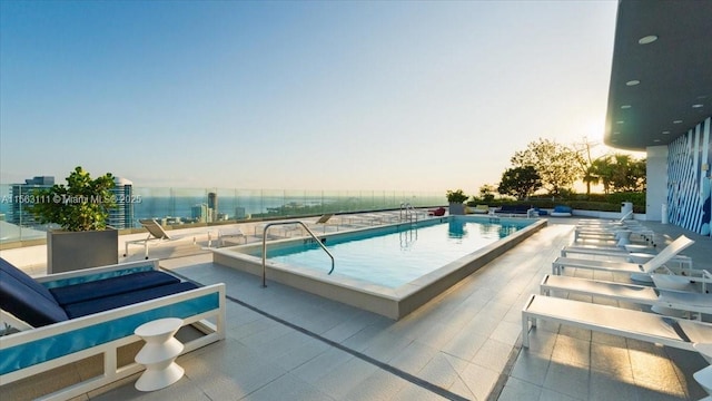 pool at dusk with a patio