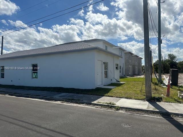 view of home's exterior with a lawn