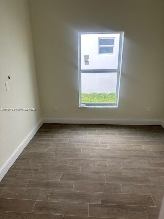 spare room with hardwood / wood-style flooring