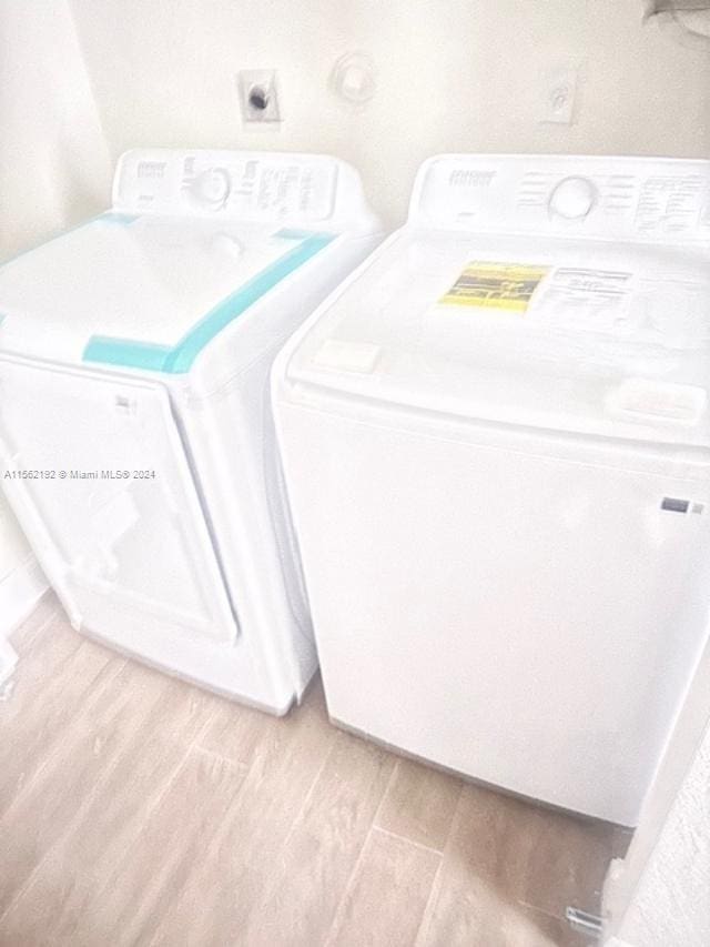 washroom featuring washer and dryer and light hardwood / wood-style floors