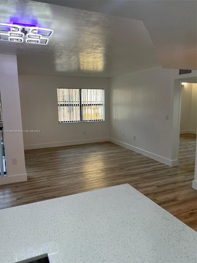 unfurnished room featuring dark hardwood / wood-style floors