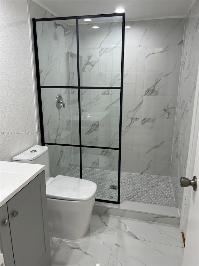 bathroom featuring toilet, tile floors, a shower with shower door, and vanity