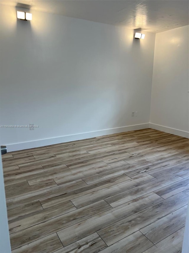 unfurnished room with light wood-type flooring