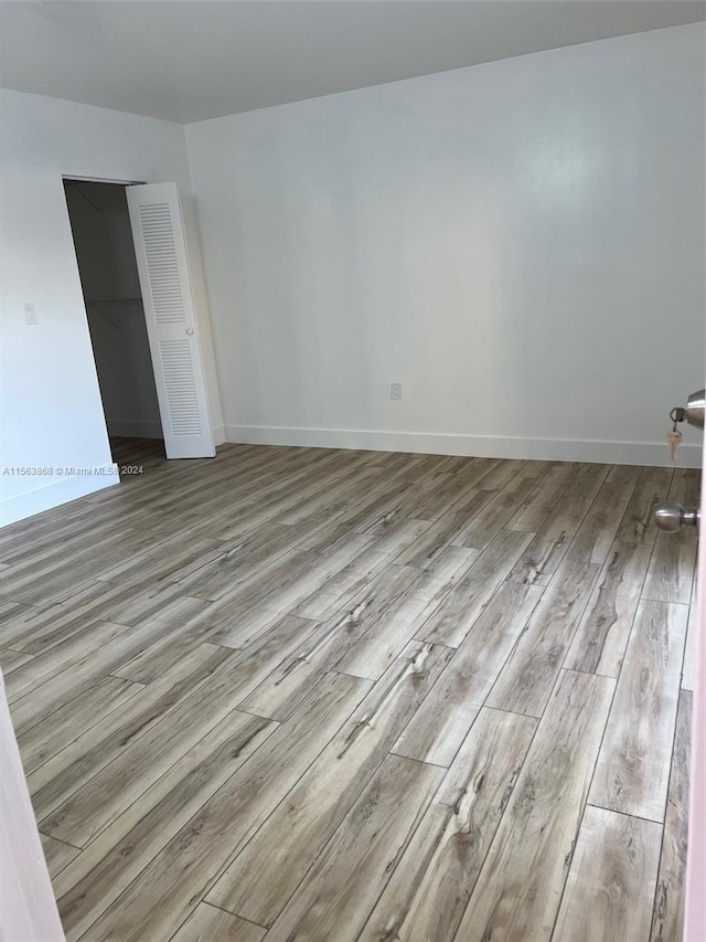 spare room with light hardwood / wood-style flooring