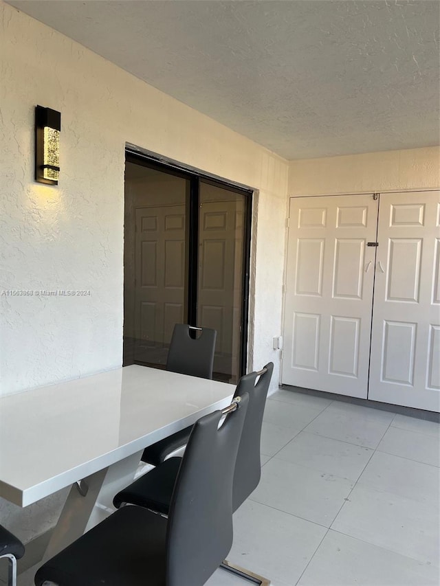 tiled home office with a textured ceiling