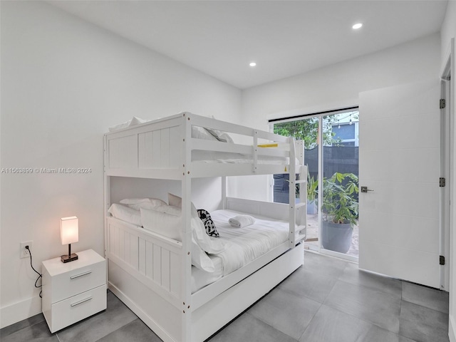 bedroom with access to exterior and light tile floors