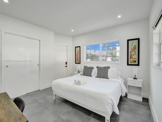 bedroom featuring light tile floors and a closet