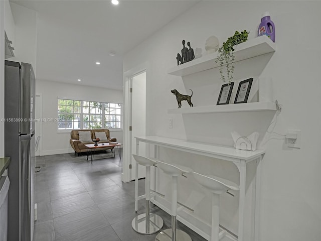 corridor featuring light tile floors