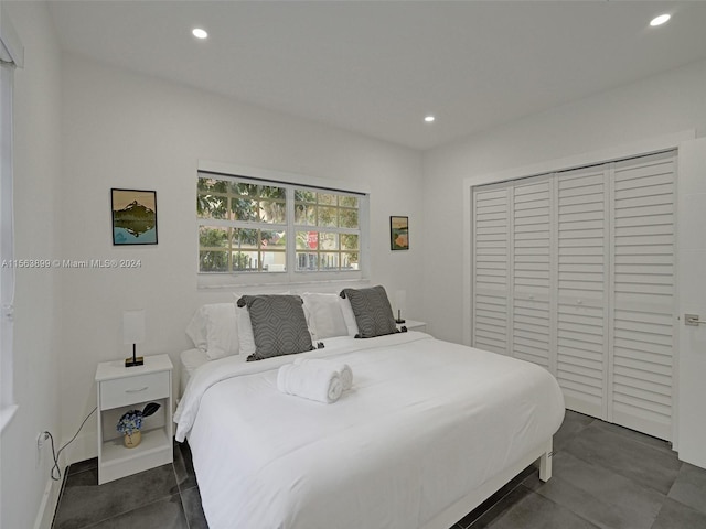 bedroom with dark tile floors