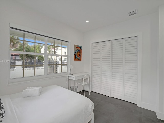 bedroom featuring dark tile floors