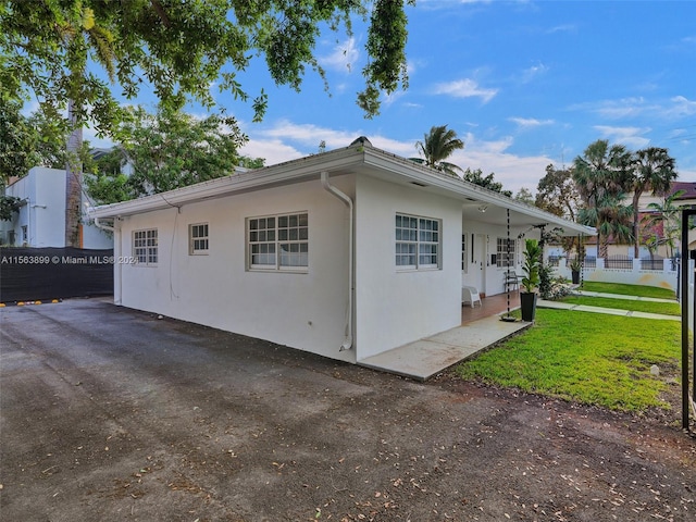 view of side of property with a lawn