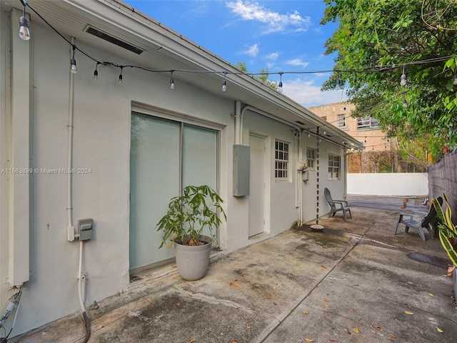 view of side of home with a patio area