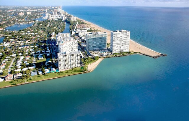 birds eye view of property featuring a beach view and a water view