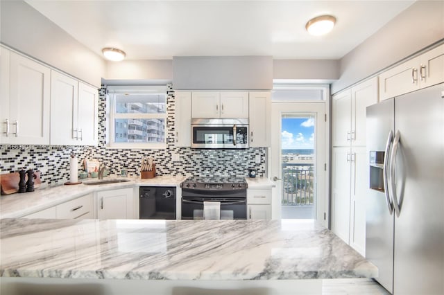 kitchen featuring white cabinets, a sink, and black appliances