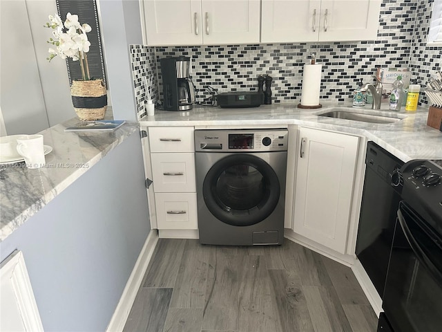 washroom with laundry area, dark wood-style floors, washer / clothes dryer, and a sink